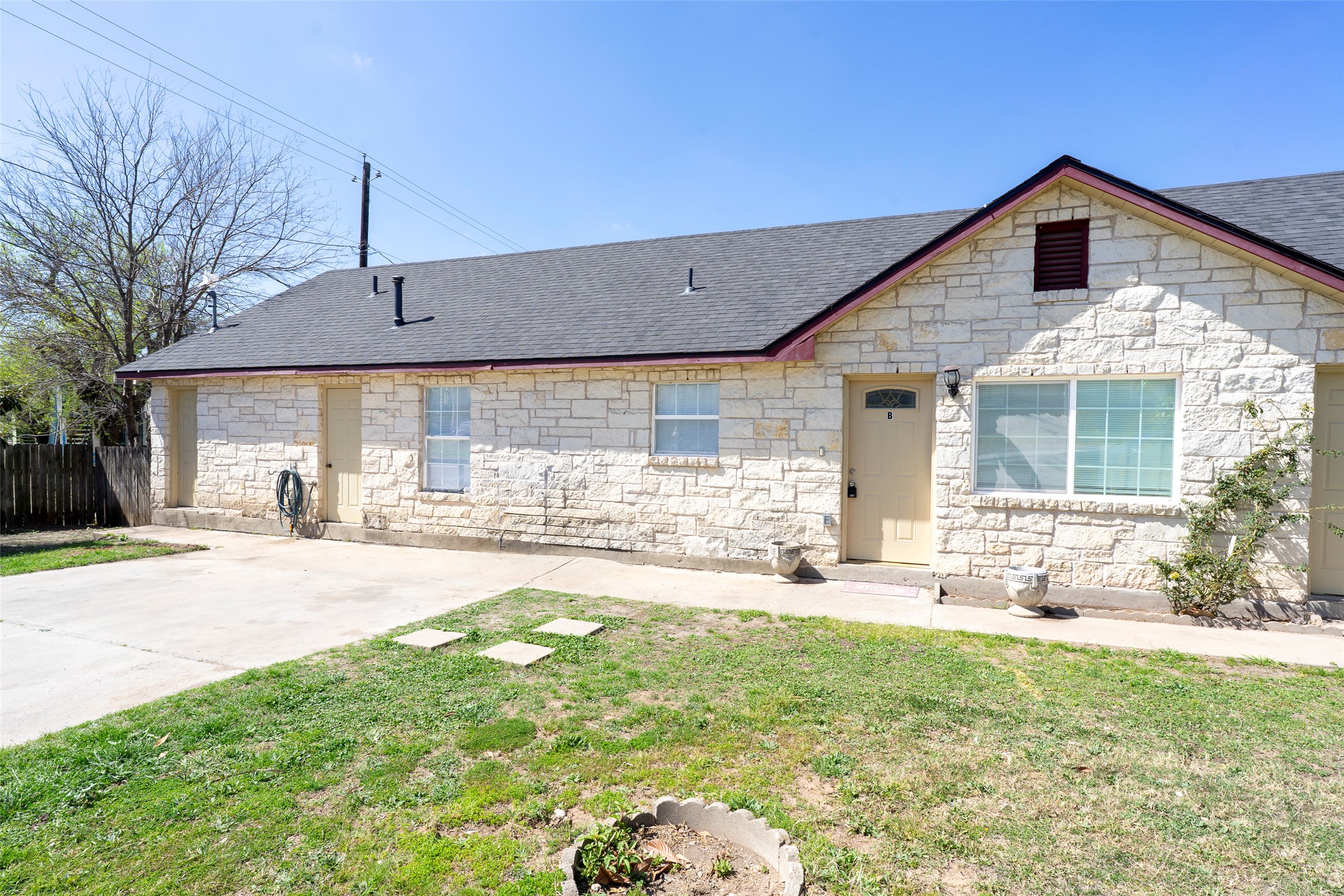 505 East Applegate Drive, Unit B Austin, TX 78753 - Photo 1 of 1 View of front of home featuring stone siding and roof with shingles