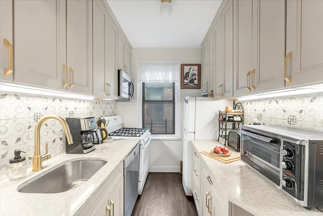 a kitchen with a sink stove and cabinets