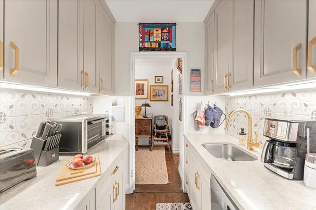 a kitchen with stainless steel appliances granite countertop a sink stove and cabinets
