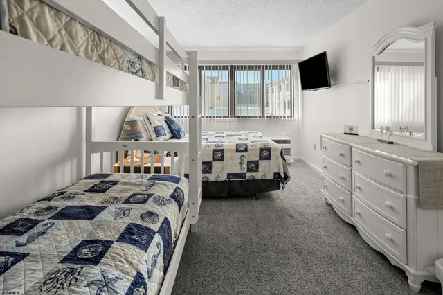 a bedroom with furniture and a flat tv screen