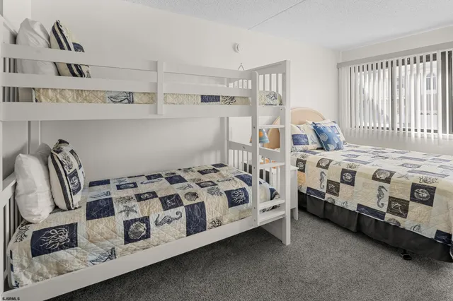 a bedroom with a bed next to a window