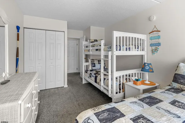 a bedroom with furniture a flat screen tv and a couch