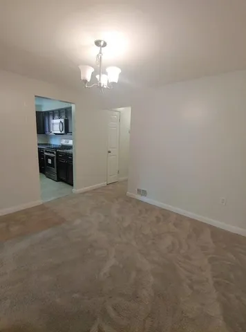 a view of a chandelier and a chandelier fan in a room