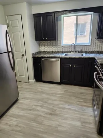 a kitchen with stainless steel appliances granite countertop a stove a sink and a granite counter tops