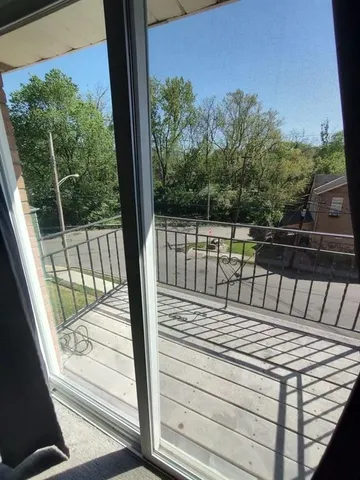 a view of a balcony with wooden floor