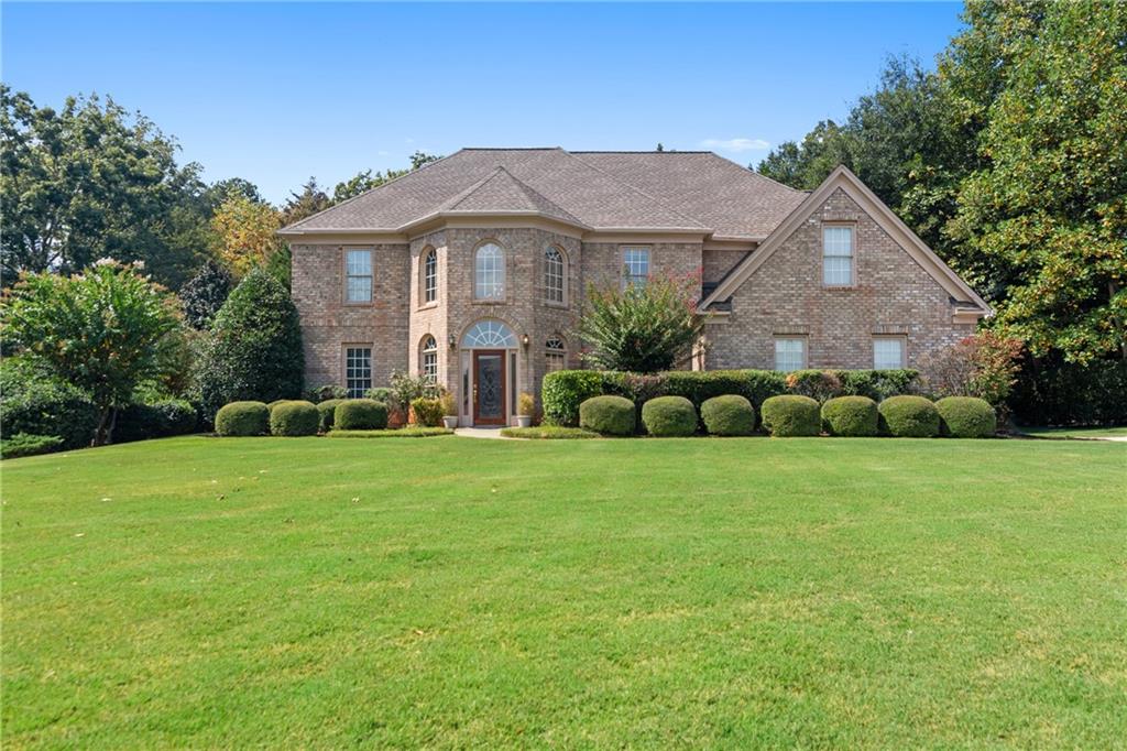a view of a house with a big yard and potted plants