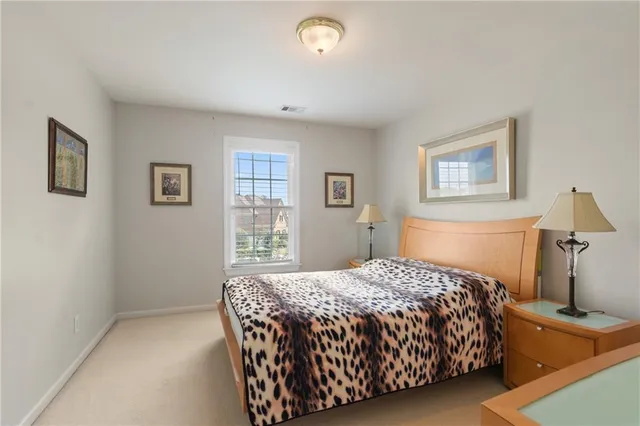 a bedroom with a large bed and a chandelier