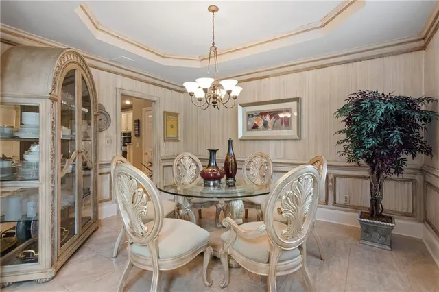 a view of a dining room with furniture and chandelier