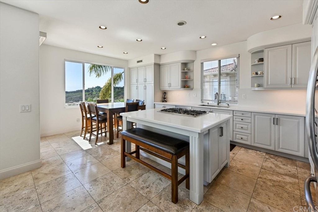18 Sable Sands Newport Coast, CA 92657 - Photo 7 of 37 a kitchen with a stove a sink and a refrigerator