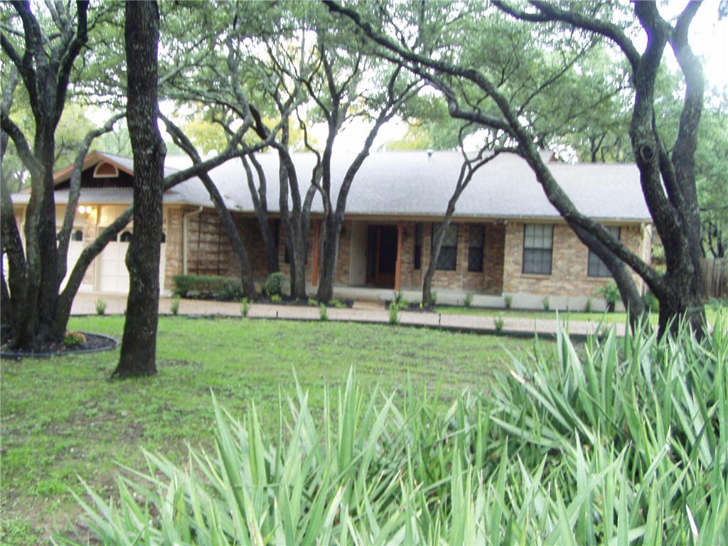 10401 Double Spur Loop Austin, TX 78759 - Photo 1 of 1 a front view of a house with garden