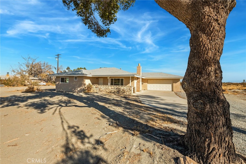 19665 Grey Mountain Road Adelanto, CA 92301 - Photo 13 of 30 a front view of a house with a yard