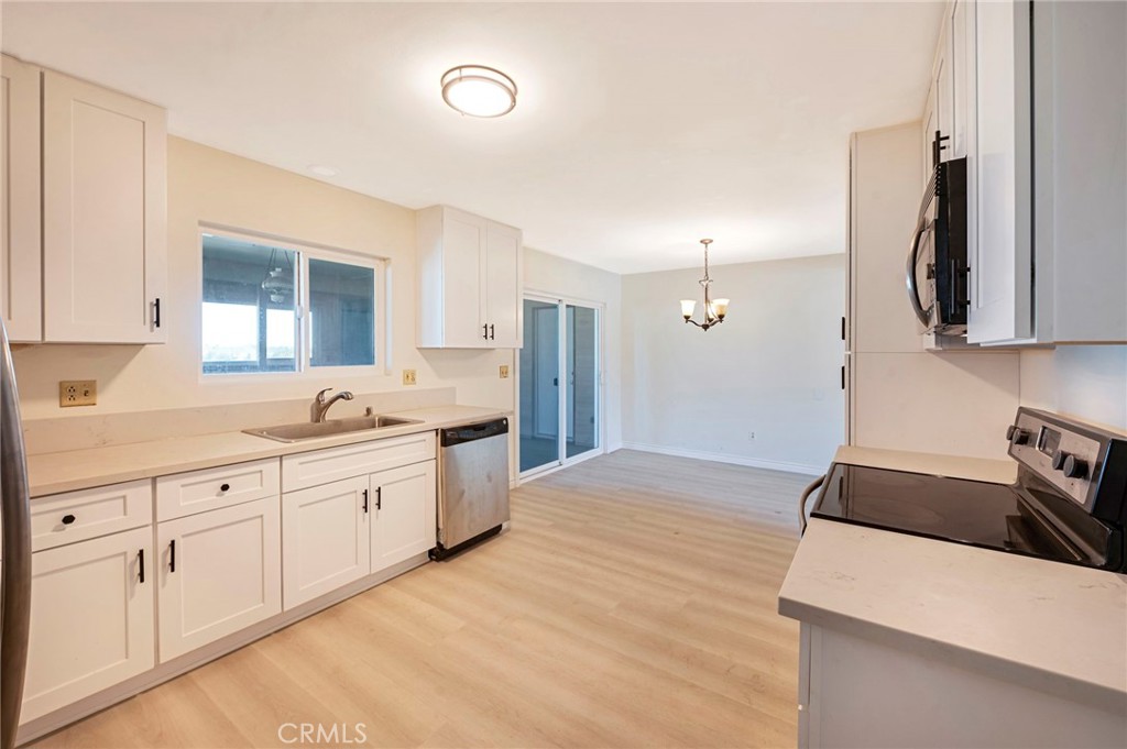 19665 Grey Mountain Road Adelanto, CA 92301 - Photo 2 of 30 a kitchen with granite countertop white cabinets and white appliances