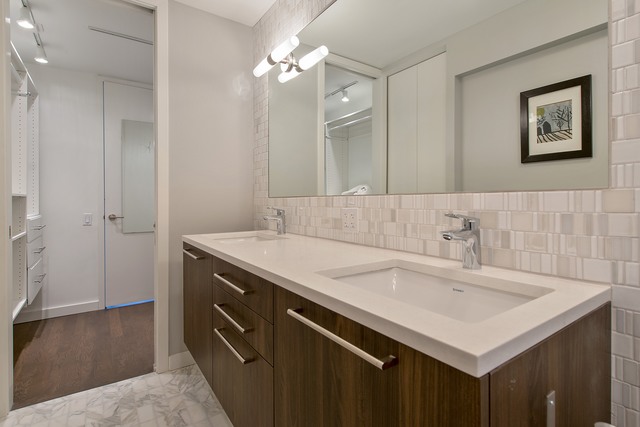 200 East Delaware Place, Unit 18F Chicago, IL 60611 - Photo 14 of 38 a bathroom with a sink and a mirror