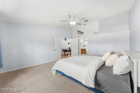 a bedroom with a bed and a ceiling fan