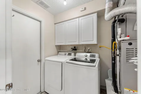 a kitchen with stainless steel appliances a refrigerator sink and white cabinets