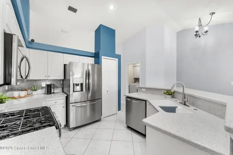 a kitchen with a sink cabinets and stainless steel appliances