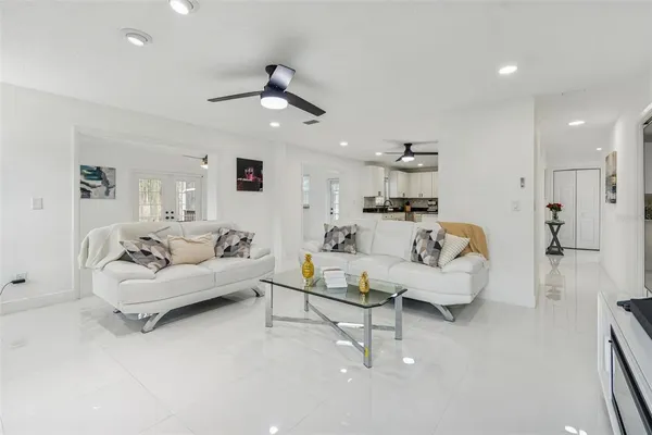 a living room with furniture and a ceiling fan