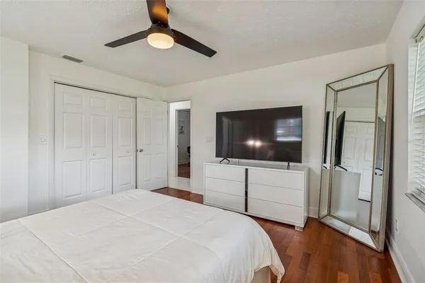 a bedroom with a bed and a flat screen tv