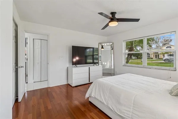 a bedroom with a bed and a flat screen tv