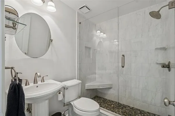 a bathroom with a sink toilet and shower