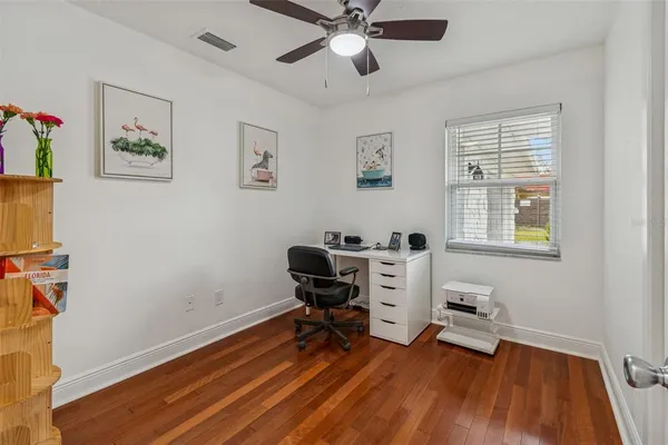 a view of a workspace with furniture and a window