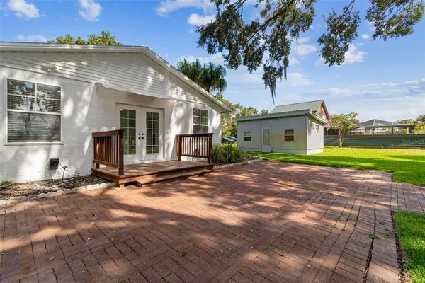 a view of a small house with a yard