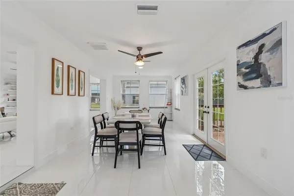 a dining room with furniture and window