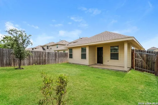 a view of a house with a yard and sitting area