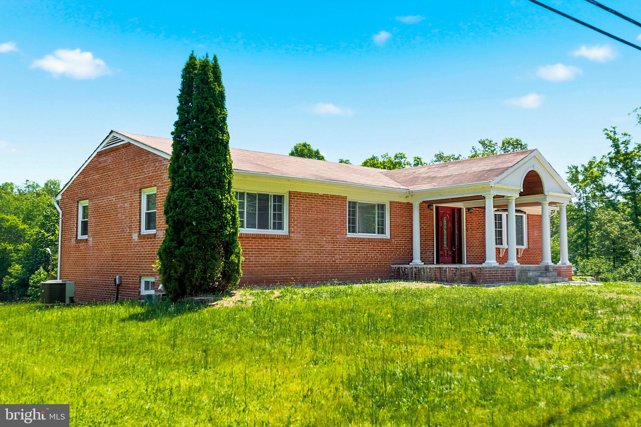 11325 Bacon Race Road Woodbridge, VA 22192 - Photo 3 of 54 a front view of a house with a garden and yard