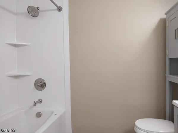 a bathroom with a toilet and a tub