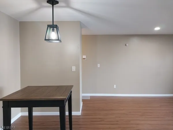 a view of a room with a table and chandelier