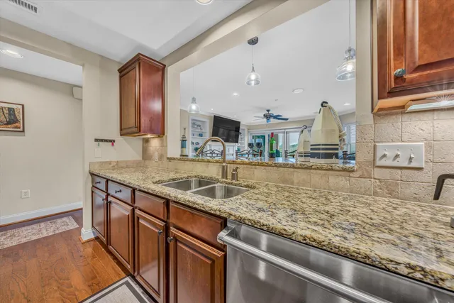 a kitchen with stainless steel appliances granite countertop a sink and a counter space