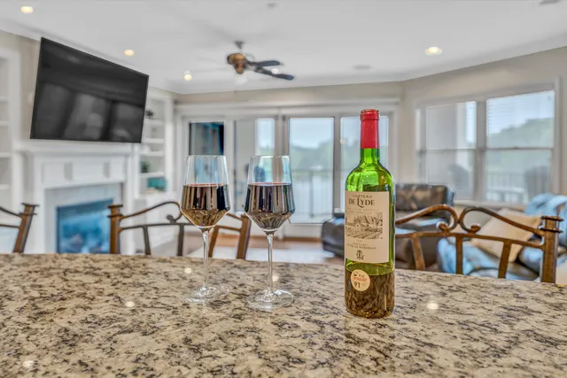 a living room with furniture a flat screen tv and a large window