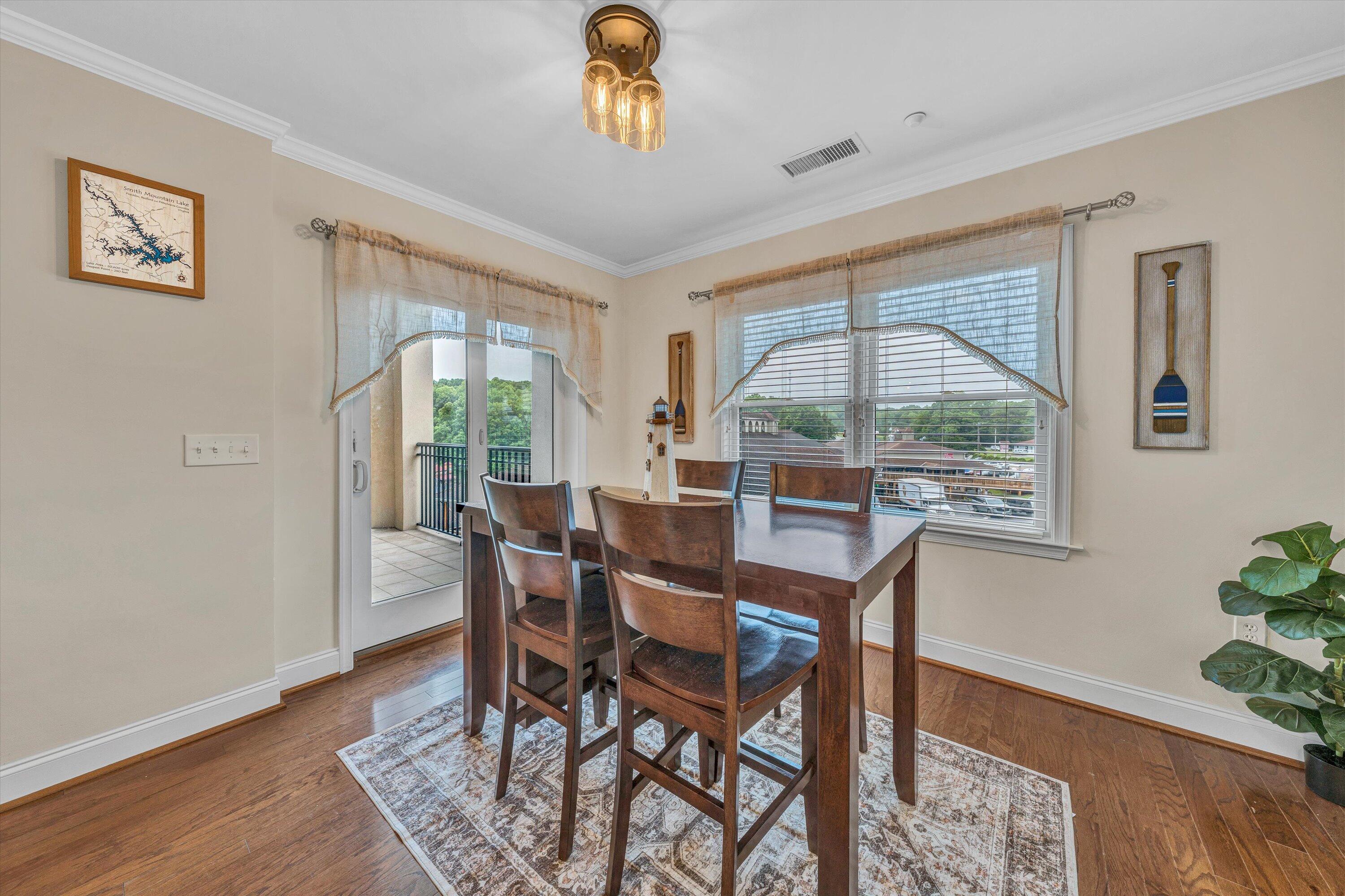 100 Bridgewater Pointe Place, Unit 401 Moneta, VA 24121 - Photo 15 of 39 a view of a dining room with furniture window and wooden floor