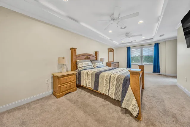 a spacious bedroom with a bed and a chandelier