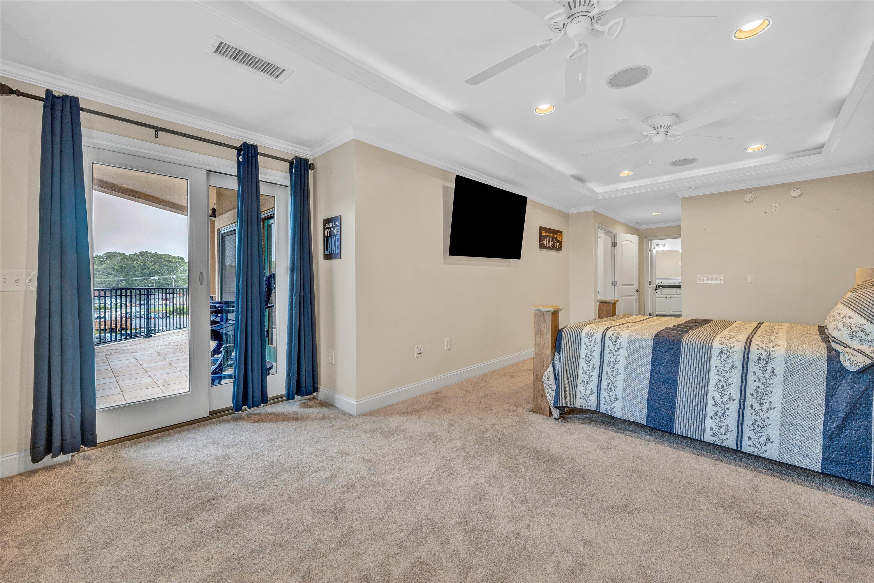 100 Bridgewater Pointe Place, Unit 401 Moneta, VA 24121 - Photo 18 of 39 a living room with a large bed and a flat screen tv