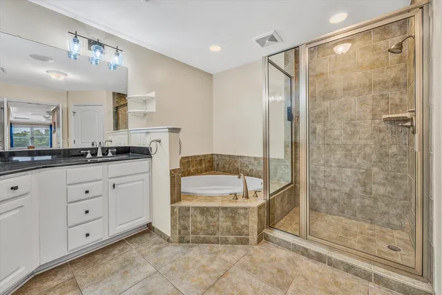 a bathroom with a double vanity sink a mirror and a shower