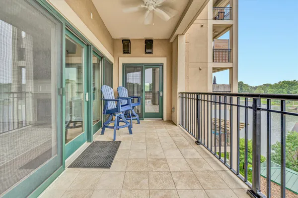 a view of a porch with wooden floor and furniture