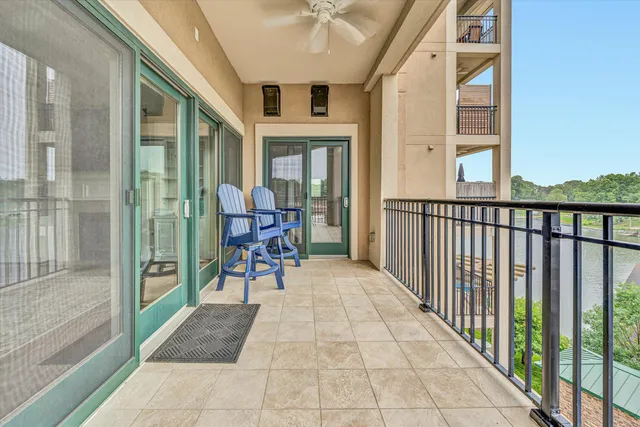 a view of a porch with wooden floor and furniture