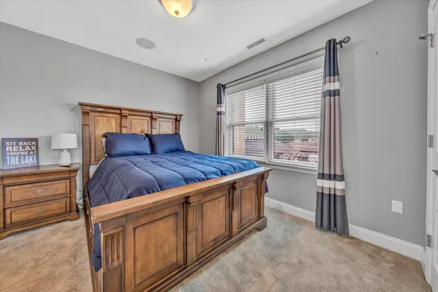 a bedroom with a large bed and a window