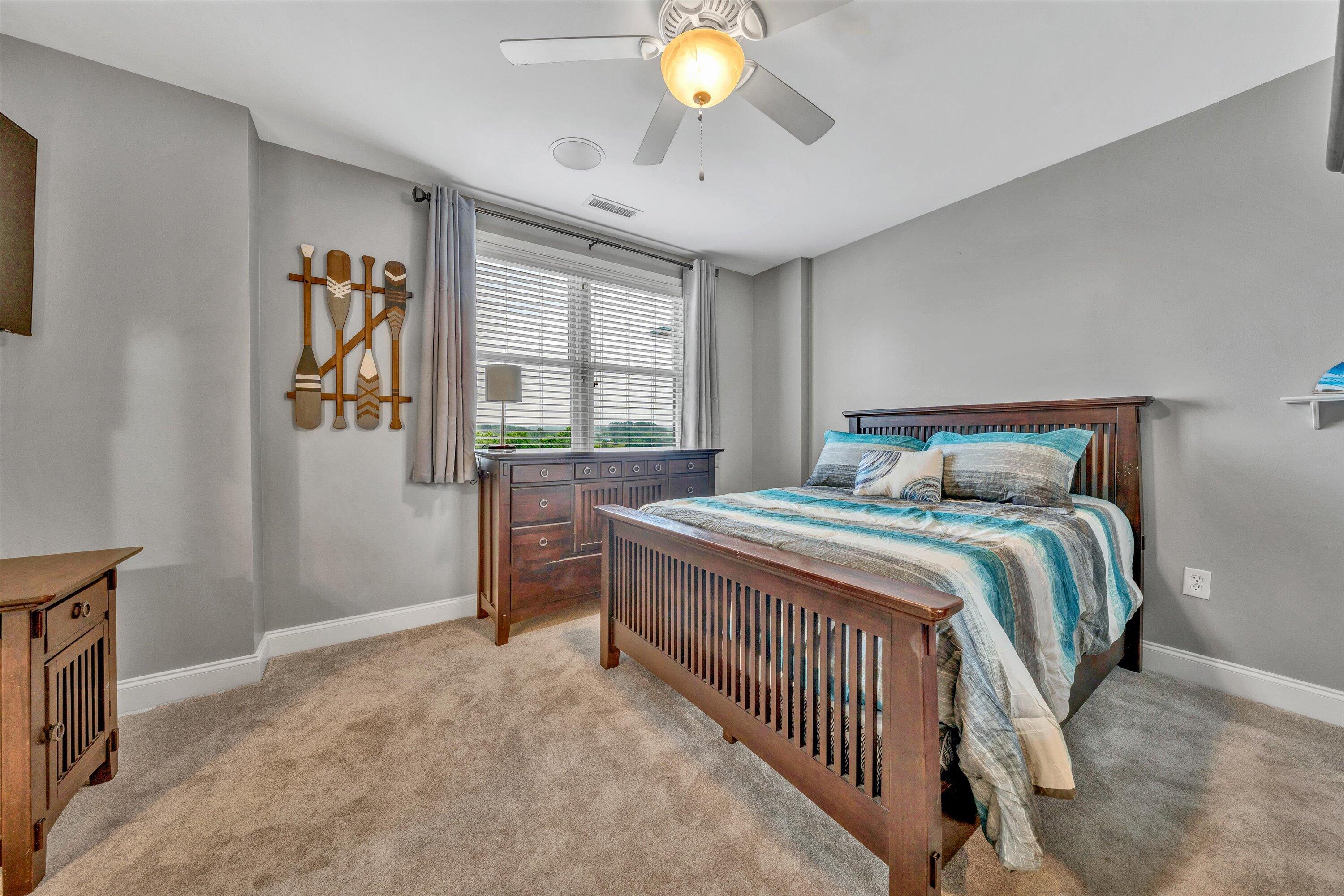 100 Bridgewater Pointe Place, Unit 401 Moneta, VA 24121 - Photo 32 of 39 a bedroom with a bed and a chandelier