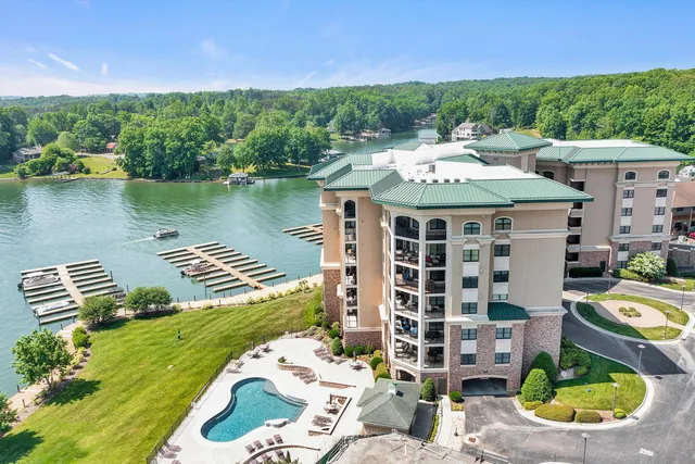 an aerial view of a house with a garden and lake view
