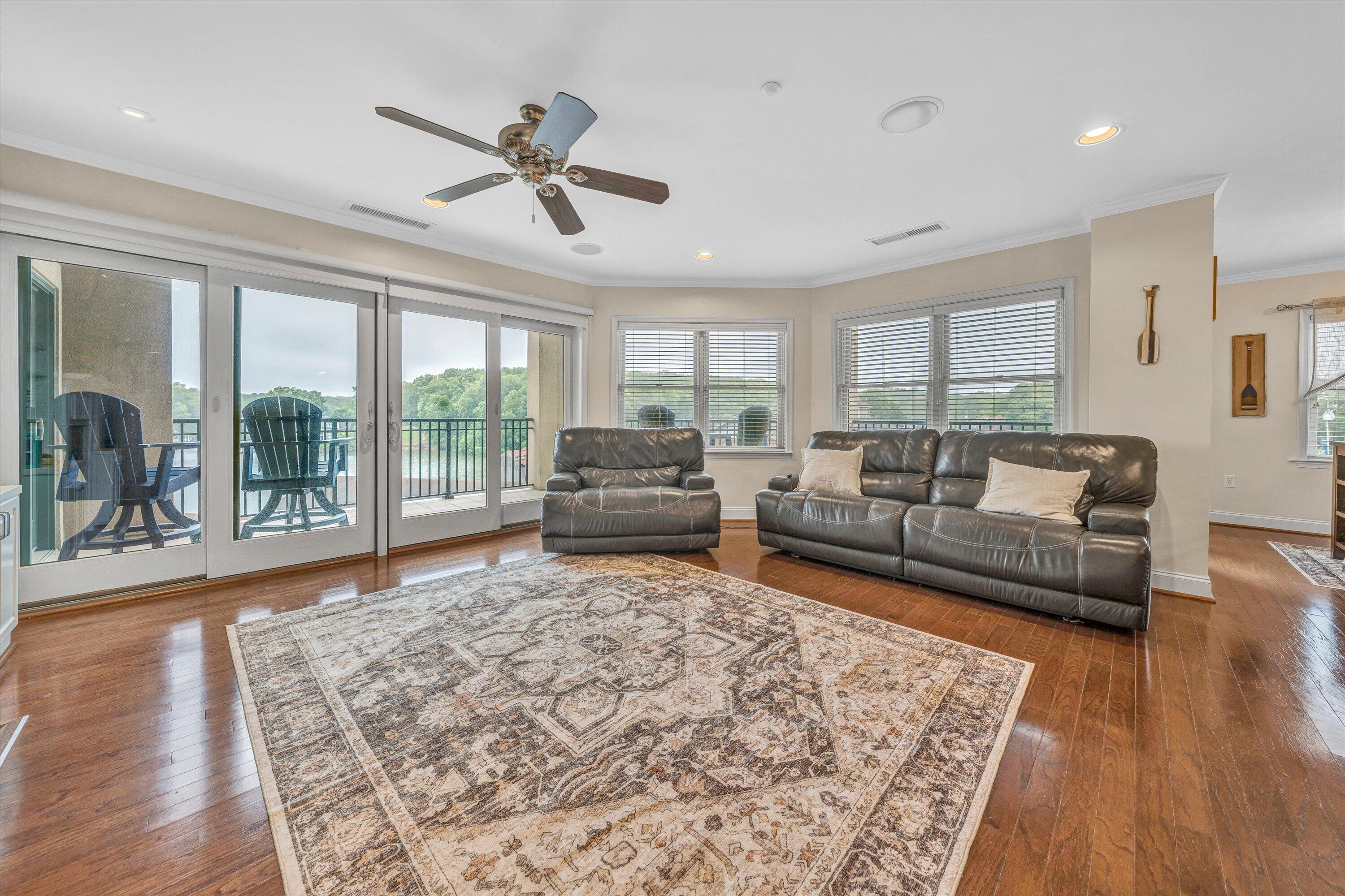 100 Bridgewater Pointe Place, Unit 401 Moneta, VA 24121 - Photo 4 of 39 a living room with furniture floor to ceiling window and wooden floor