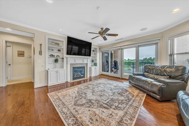 a living room with a flat screen tv and a fireplace