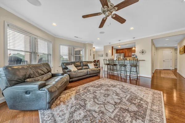 a living room with furniture ceiling fan and a rug