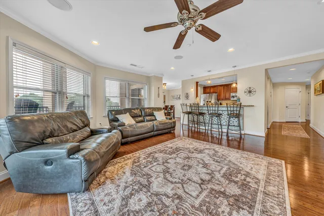 a living room with furniture ceiling fan and a rug