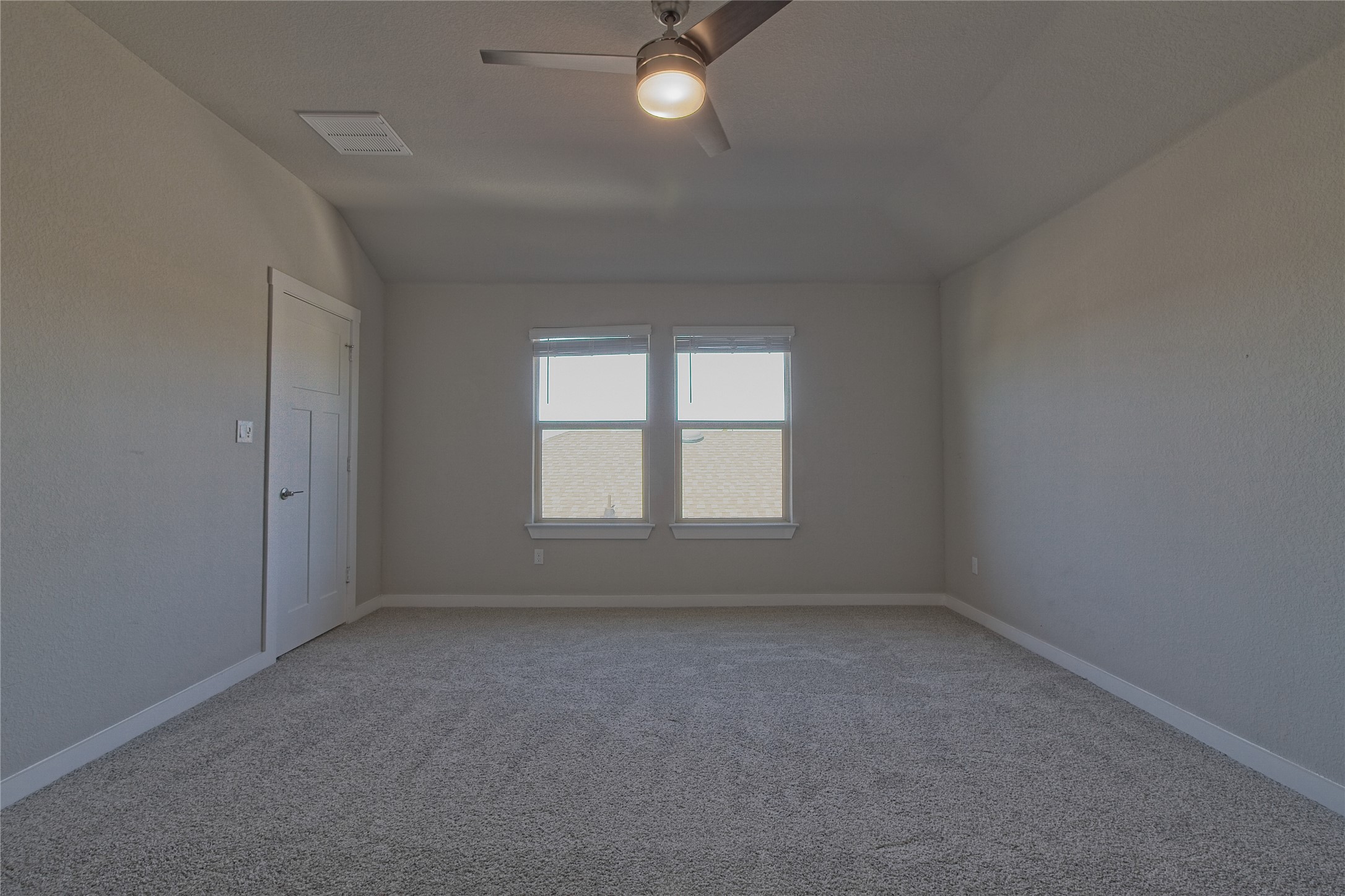 425 Coda Crossing Georgetown, TX 78633 - Photo 15 of 36 Carpeted spare room with ceiling fan and vaulted ceiling