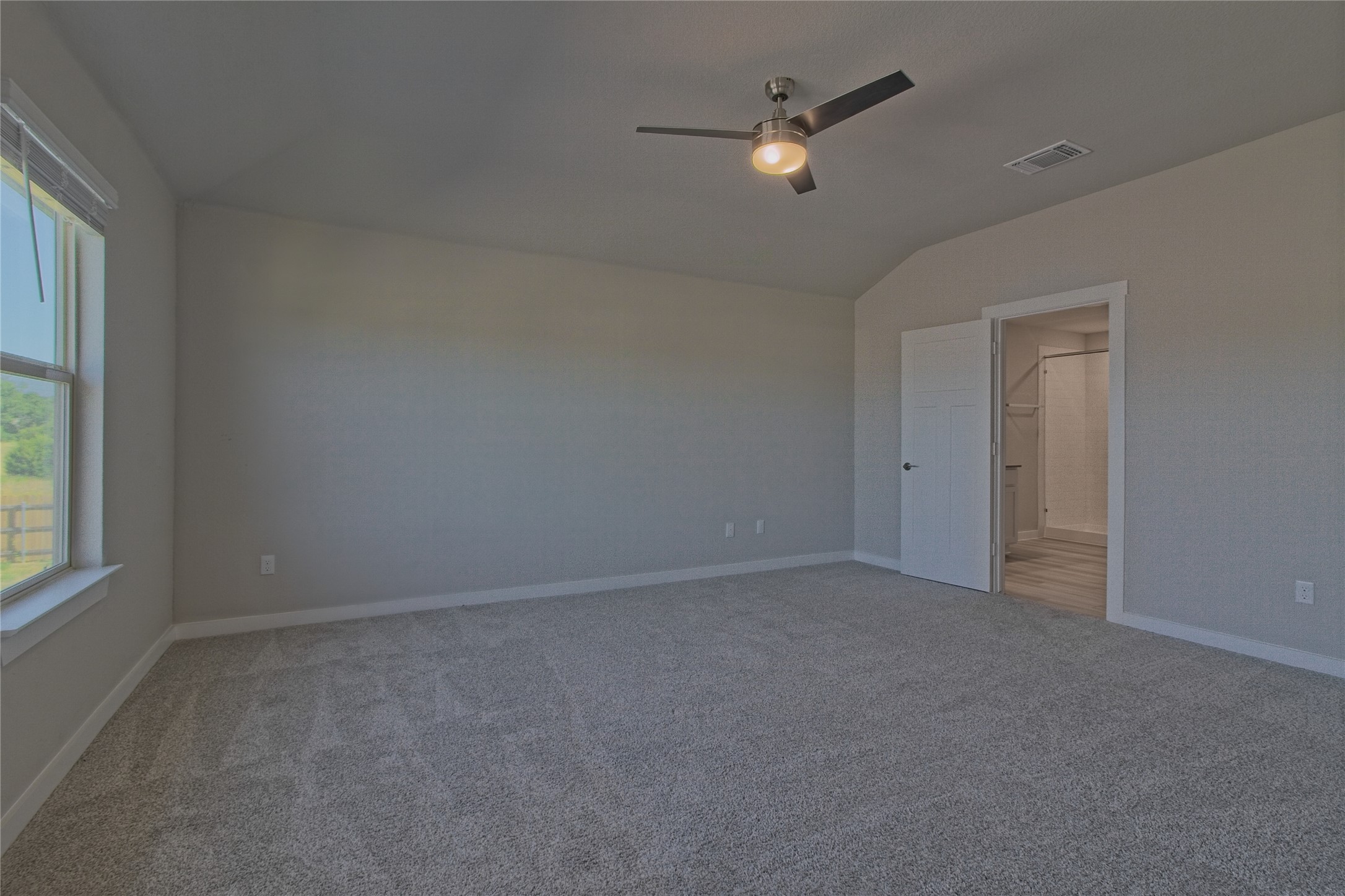 425 Coda Crossing Georgetown, TX 78633 - Photo 16 of 36 Unfurnished room with lofted ceiling, ceiling fan, and light carpet