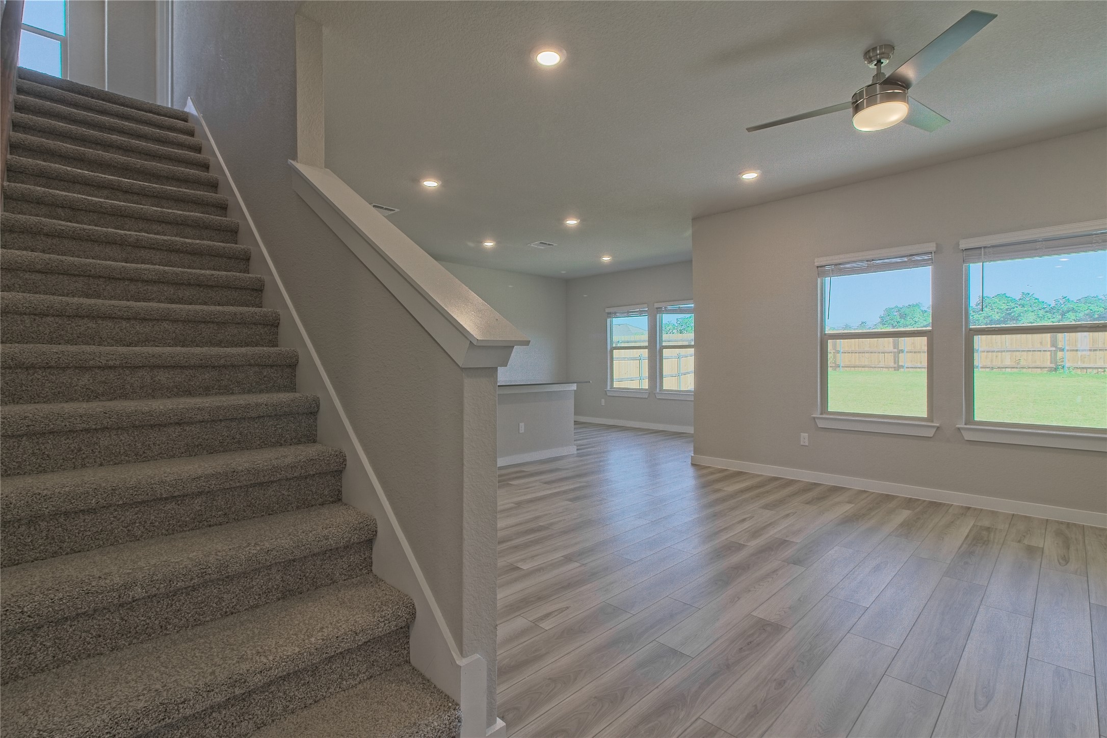 425 Coda Crossing Georgetown, TX 78633 - Photo 6 of 36 Stairway with wood finished floors, ceiling fan, and recessed lighting