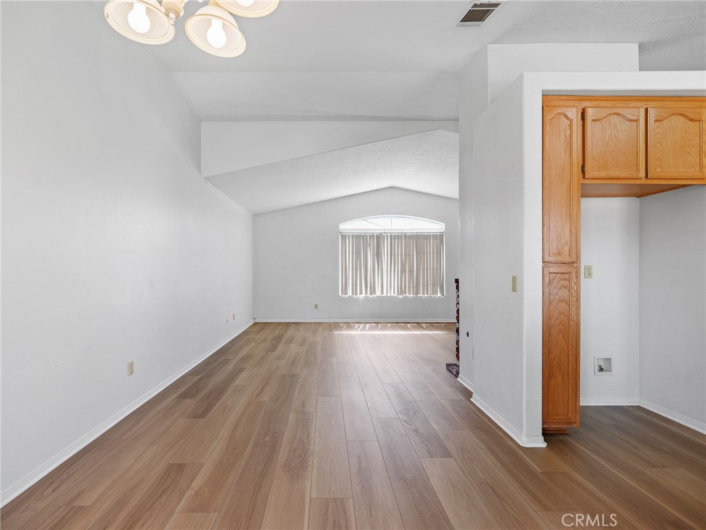 19068 Goleta Street Hesperia, CA 92345 - Photo 24 of 34 a view of empty room with wooden floor and fan